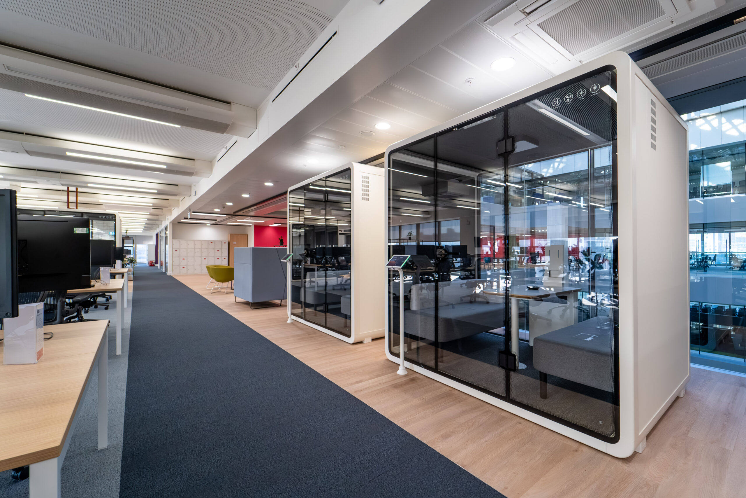 Modern office space with glass meeting pods
