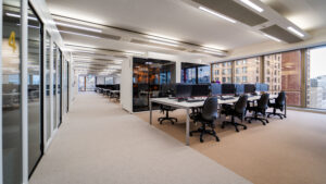 Modern open-plan office with natural lighting, acoustic pods, and ergonomic seating designed to support a neuroinclusive work environment