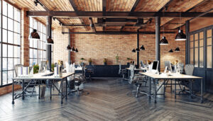 Open industrial office with natural light and ergonomic seating
