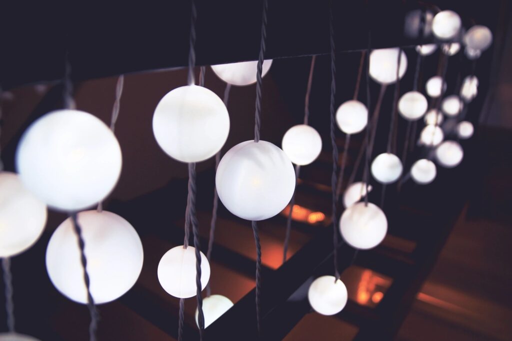 Soft ambient string lighting with spherical bulbs, ideal for creating a calming, sensory-friendly environment in neuroinclusive workspaces