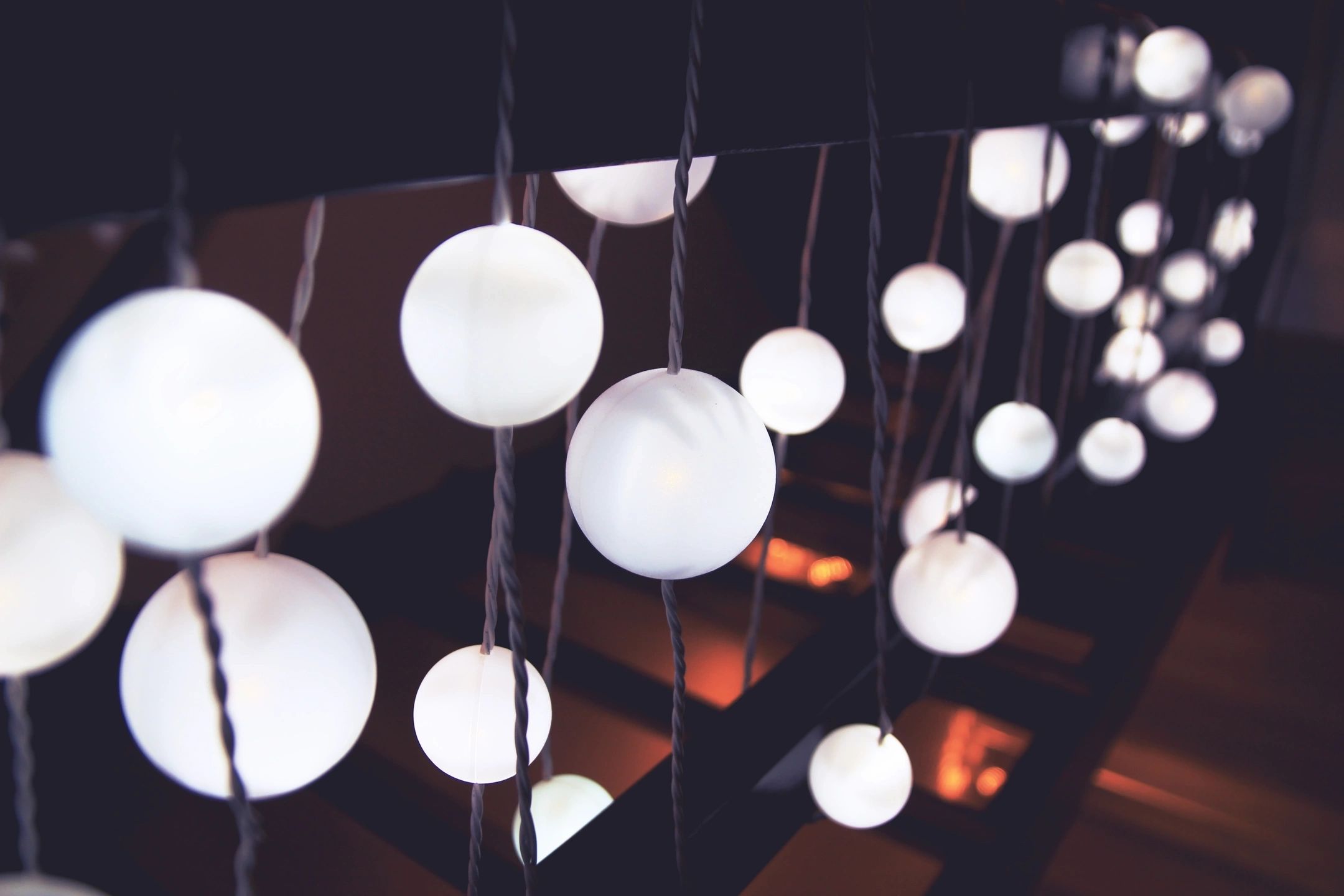 Soft ambient string lighting with spherical bulbs, ideal for creating a calming, sensory-friendly environment in neuroinclusive workspaces